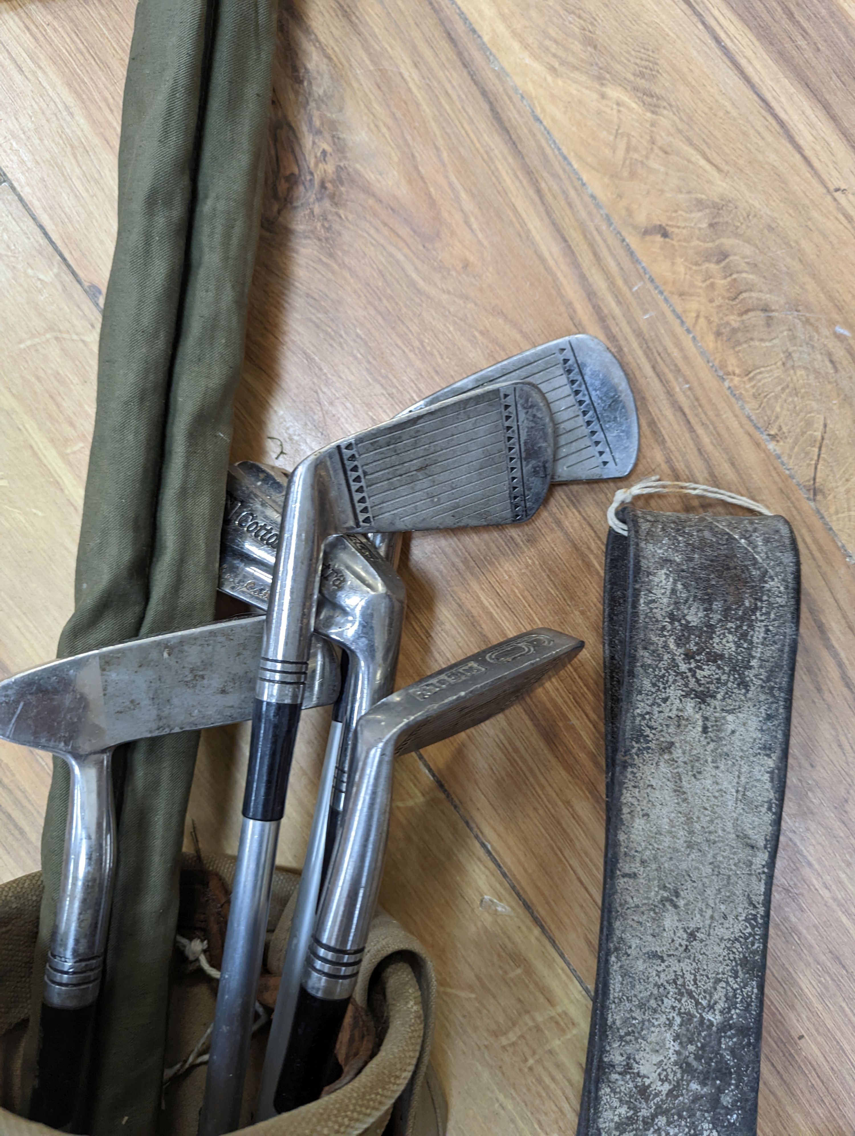 A split cane fishing rod, quantity of golf clubs, cows bell